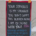 Poster written in English and Korean reads "Your struggle is my struggle. You don't carry this burden alone. I am 'han' (oneness in sorrow) with you” at a "Ktown for Black Lives" event, Koreatown, 2020, KRT.D.B1.11.3492 