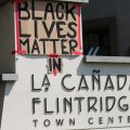 Posters taped to La Cañada town shopping center sign read "Black Lives Matter" and "in" at the Rally for Black Lives eventLa Cañada, 2020, KRT.D.B1.15.4769 