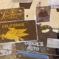 Case display with california plate with a pegasus, photographs, custom garbage pail kid, artwork by Estevan Oriol