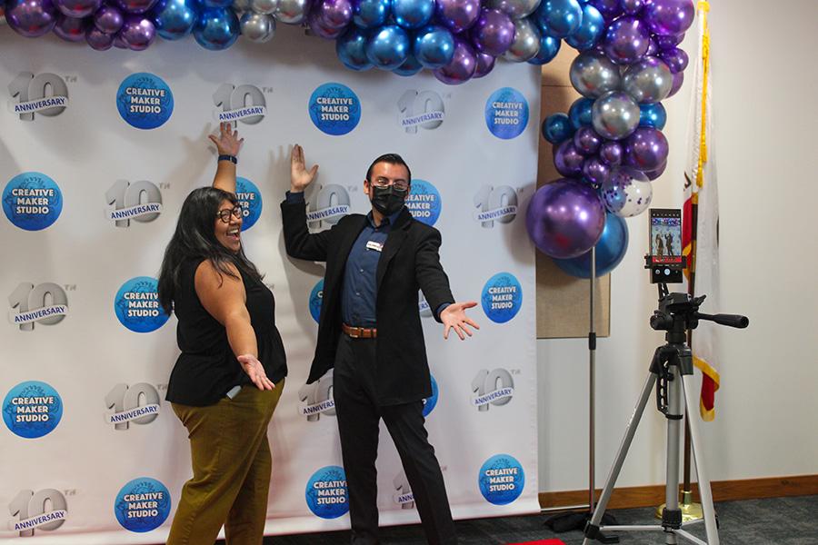 Attendees taking pictures with the 10th anniversary photobooth