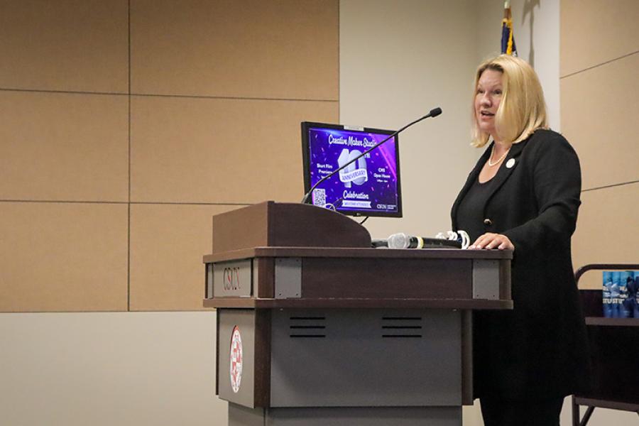 President Beck speaking at the CMS 10th Anniversary Celebration behind a podium