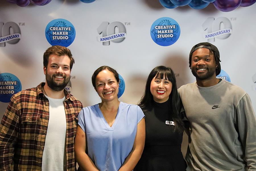 Four people posing in front of the CMS photoshoot