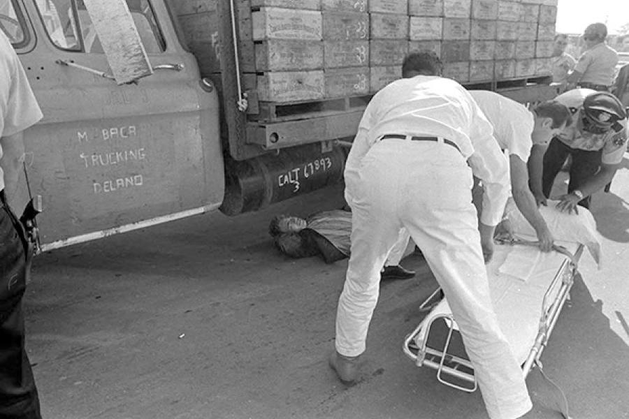 Farmworker Manuel Rivera lays injured on the ground after being run over by a truck driver in front of a packing shed. Delano, October 15, 1966. Photograph by Emmon Clarke.