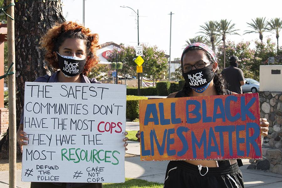 Two protesters holding signs