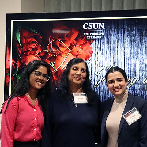 Two scholarship winners and the scholarship sponsor at CSUN's University Library