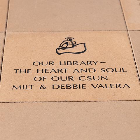 Library paver stone engraved with “Our Library — the Heart and Soul of our CSUN." - Milt and Debbie Valera