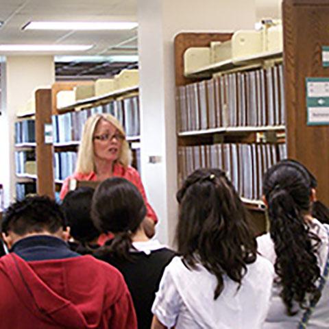 Librarian Coleen Martin giving a tour to outreach students.