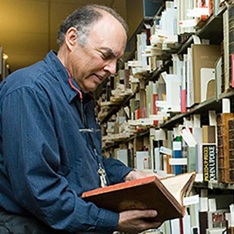 Tony Gardner browsing books in Special Collections