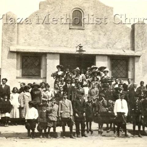 A group of people standing in front of a building