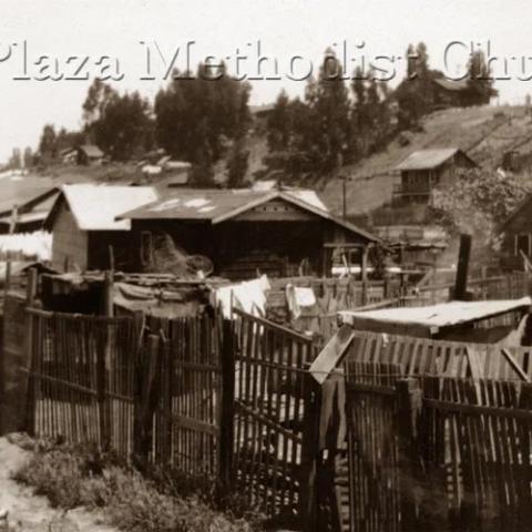 A fence and some houses within