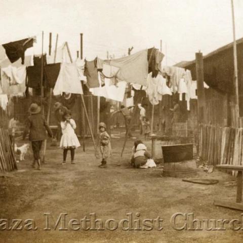 Clothes hung out to dry and a few kids playing