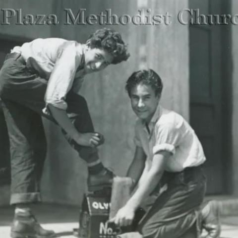 A man polishing another mans shoes