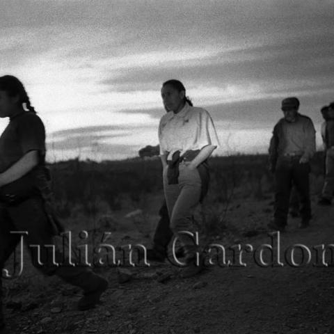 People walking in a line in a field