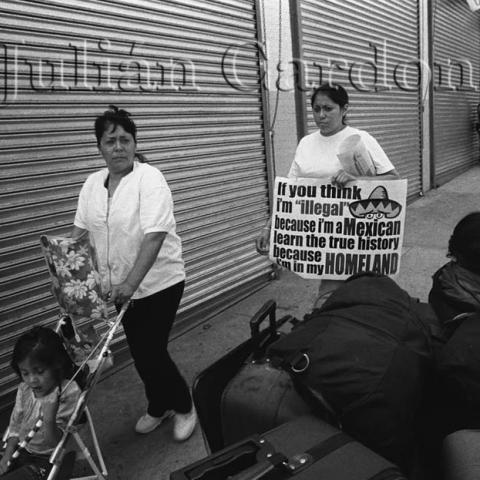 Women walking with strollers and protest signs