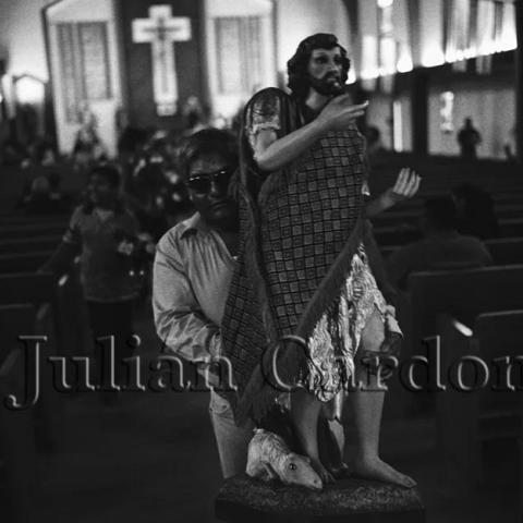 A man carrying a statue of St John