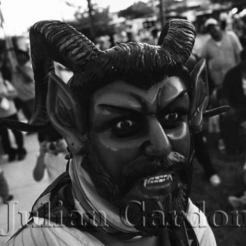 A man wearing the mask of a devil