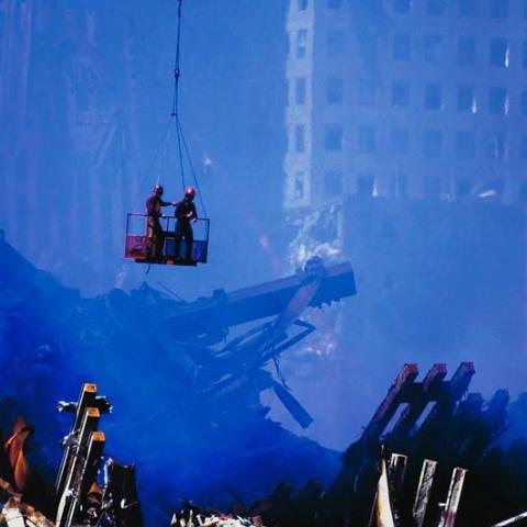 Rescue workers hanging off a crane