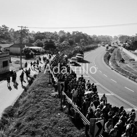 A huge population walking alongside the road.