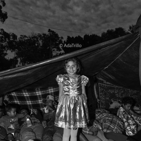 A young girl posing in a camp.