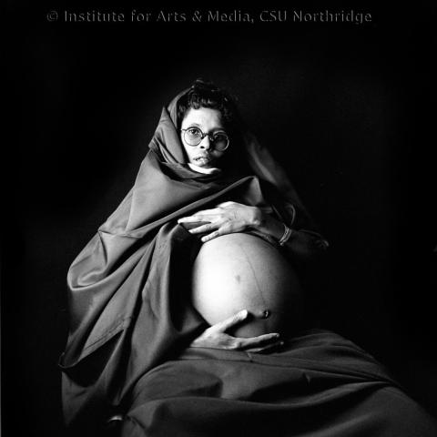 A pregnant woman showing her belly.
