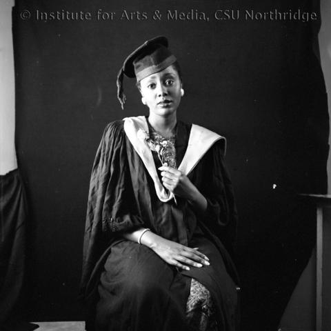 Portrait of a woman in cap and gown