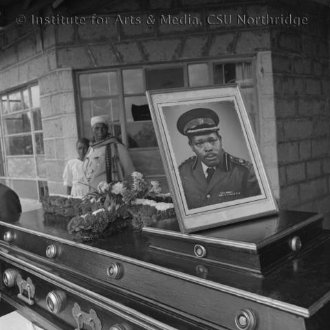 A coffin and with a photo on top