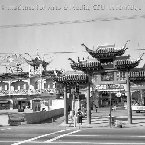 A woman standing in front of the Chinatown front entrance.