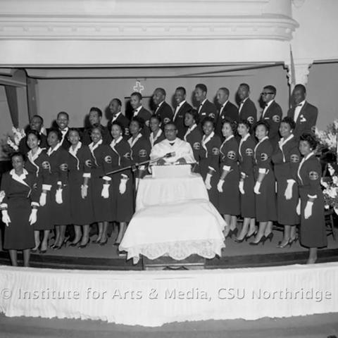 A group of men and women standing on a stage