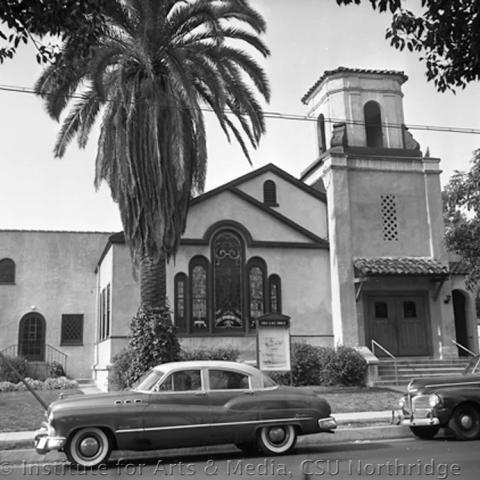 Car in front of a church.