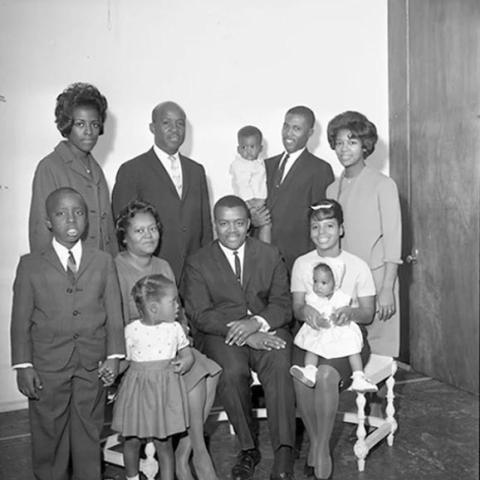 A group of men, women and children.