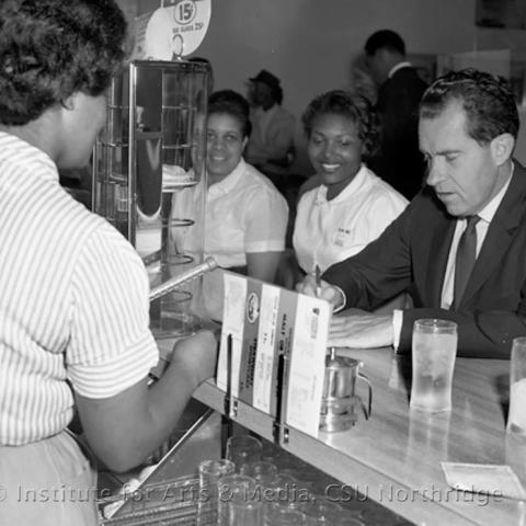 Richard Nixon with waitresses.