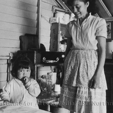 A child and a woman in a room.