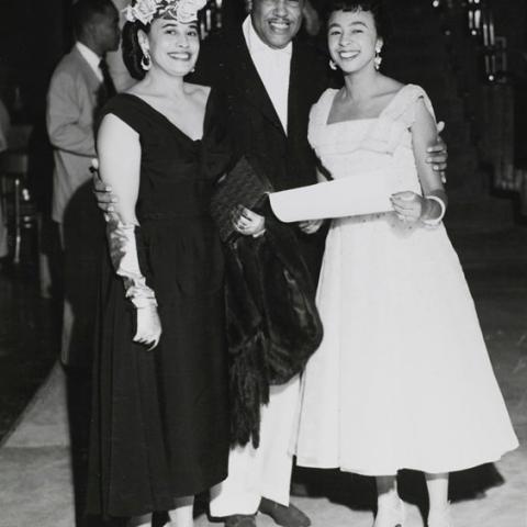 Man posing with two women.