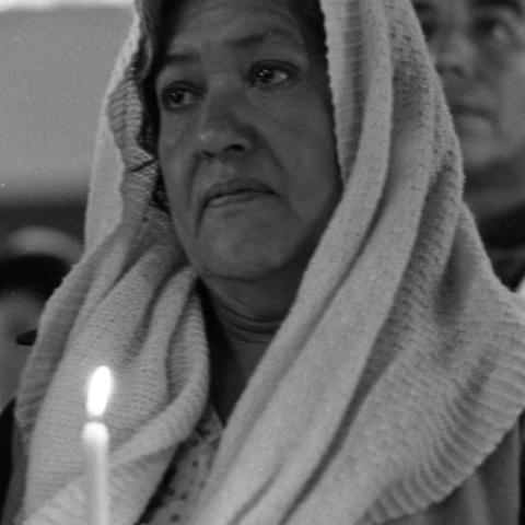 A woman holding a candle.