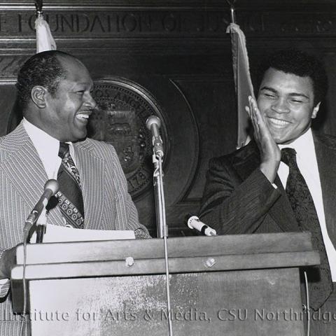 Tom Bradley with Muhammad Ali on the podium.