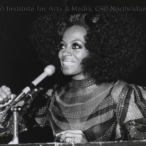 Diana Ross in speaking into a microphone