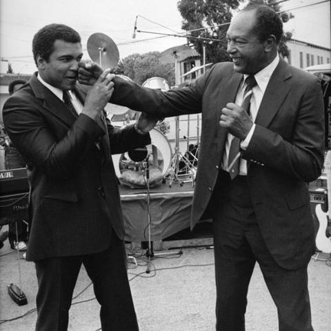 Two men pretending to box.