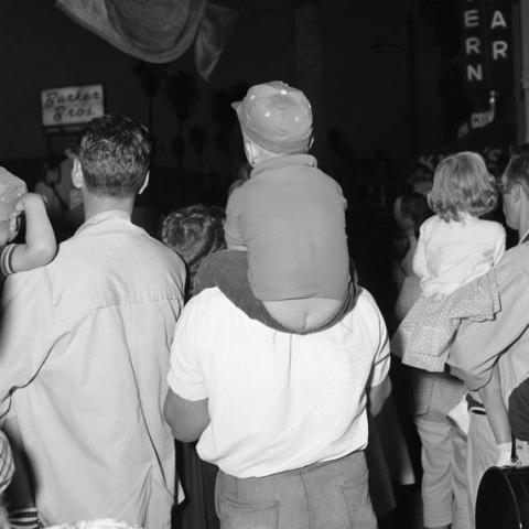 Men carrying children on their shoulders.