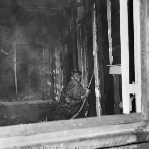 Fireman holding a water hose. 
