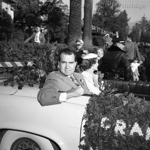 A man sitting in a open roof car.