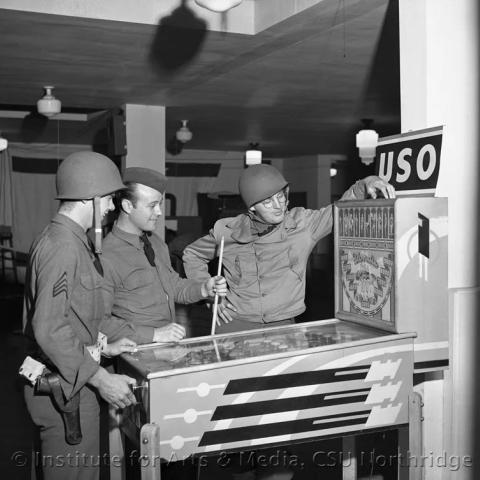 Soldier playing pinball.