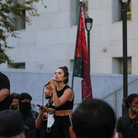 Woman speaking on the microphone.