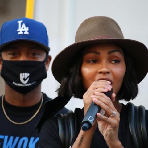 Black woman speaks into a microphone.
