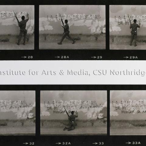 Series of negatives depicting a man with a gun writing on the wall.