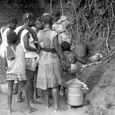 Children with water vessels.