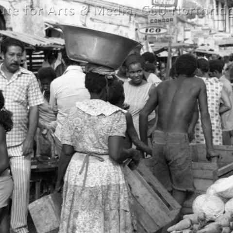 People moving around in a market.