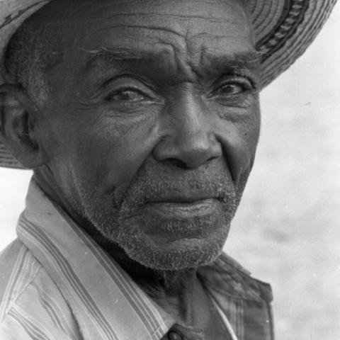An elderly man wearing a hat.