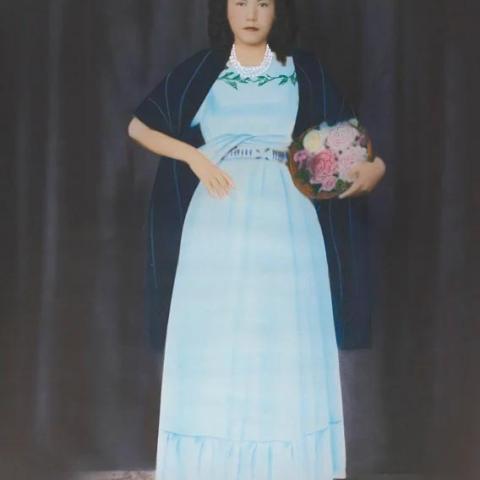 painting of a woman standing with flowers.