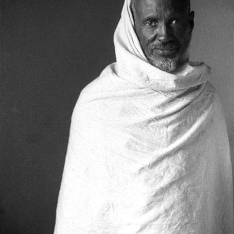Picture of a elderly man in a white cloth wrapped around