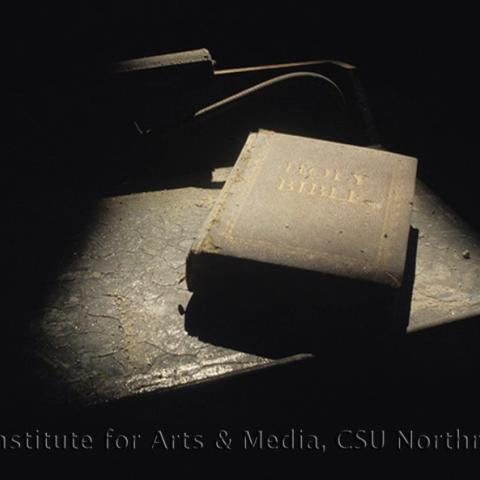 A copy of the Holy Bible covered in dust.